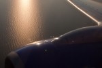 The sun is seen casting a glow across Lake Michigan en route from OSH back to Chicago Midway.